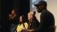 A photo of the panellists Carmen Monetanez-Callan (left), Ali MacPhail (centre) and chair Dr Mykaell Riley (right). To the left of Carmen there is a sign language interpreter.